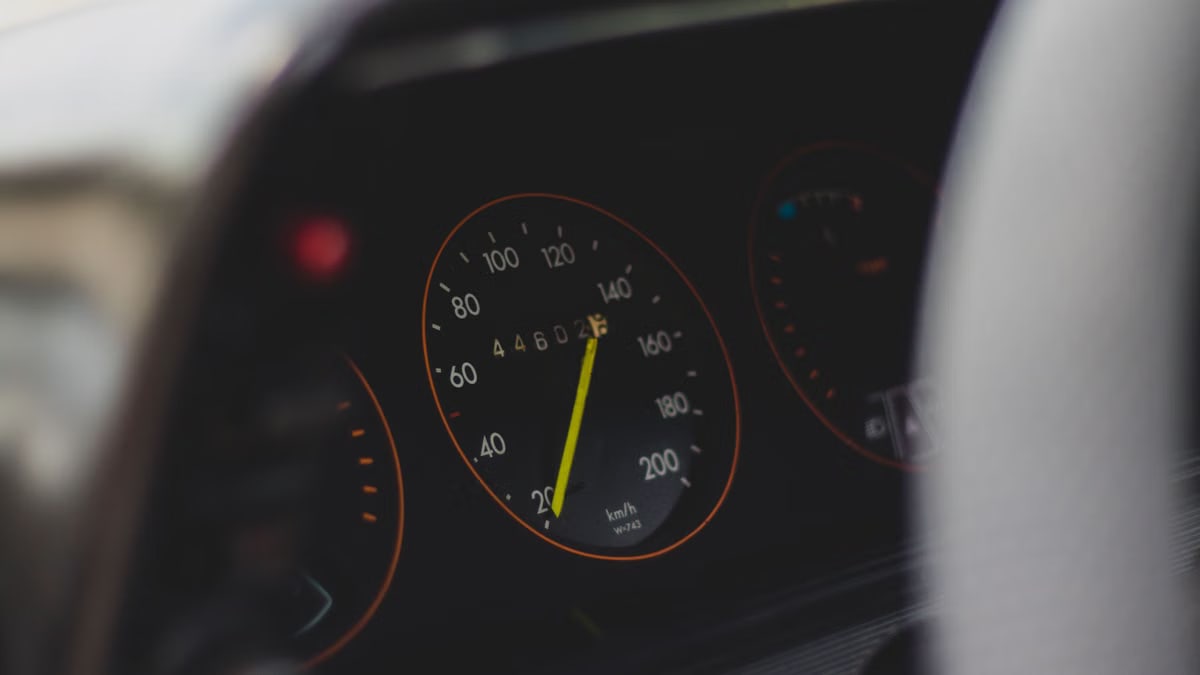 Detailed view of a car speedometer showing speed and mileage with selective focus.